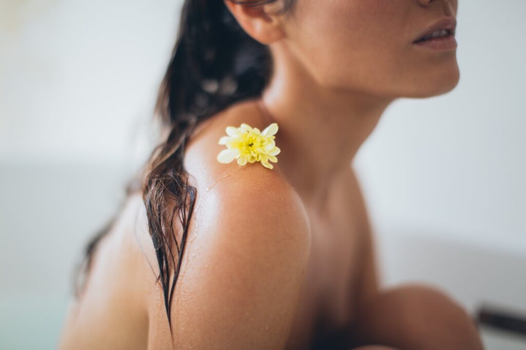 woman with white flower on her shoulder